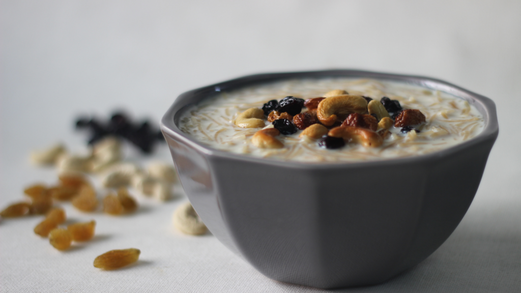 A bowl of creamy Semiya Mix dessert topped with cashews, raisins, and dry fruits.