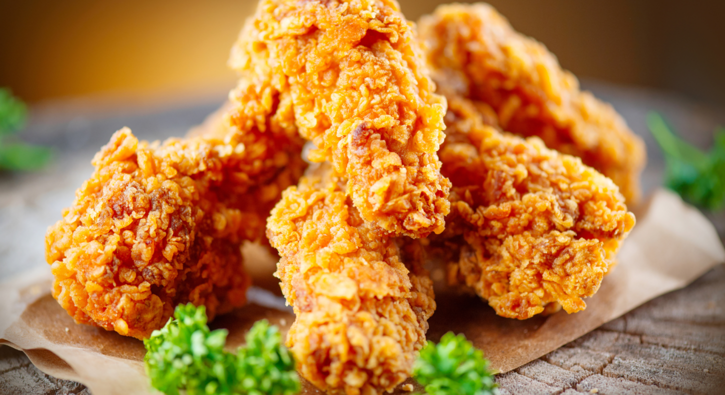 Golden crispy fried chicken pieces stacked with crunchy texture.