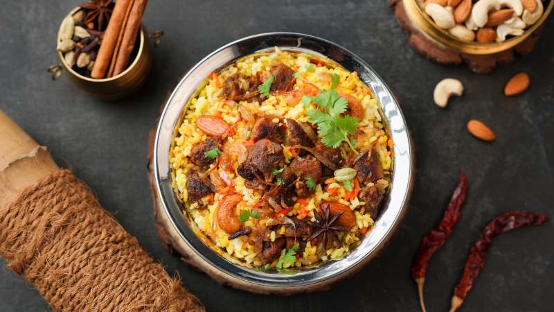 Delicious mutton biryani served in a traditional bowl with spices and dry fruits